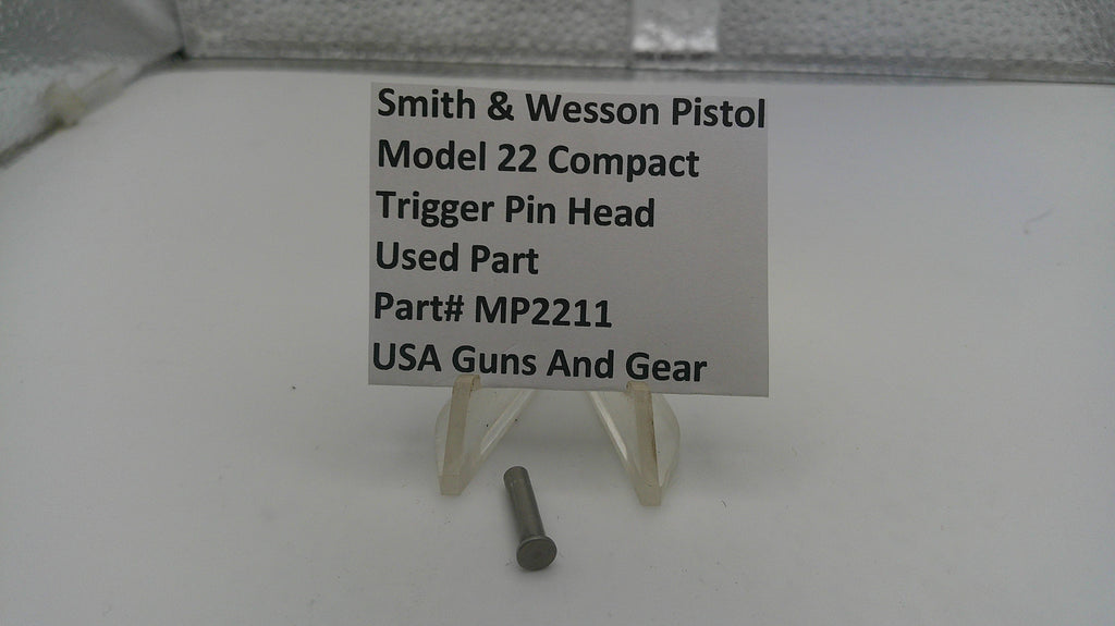 Smith & Wesson pistol trigger pin head on a stand with a label