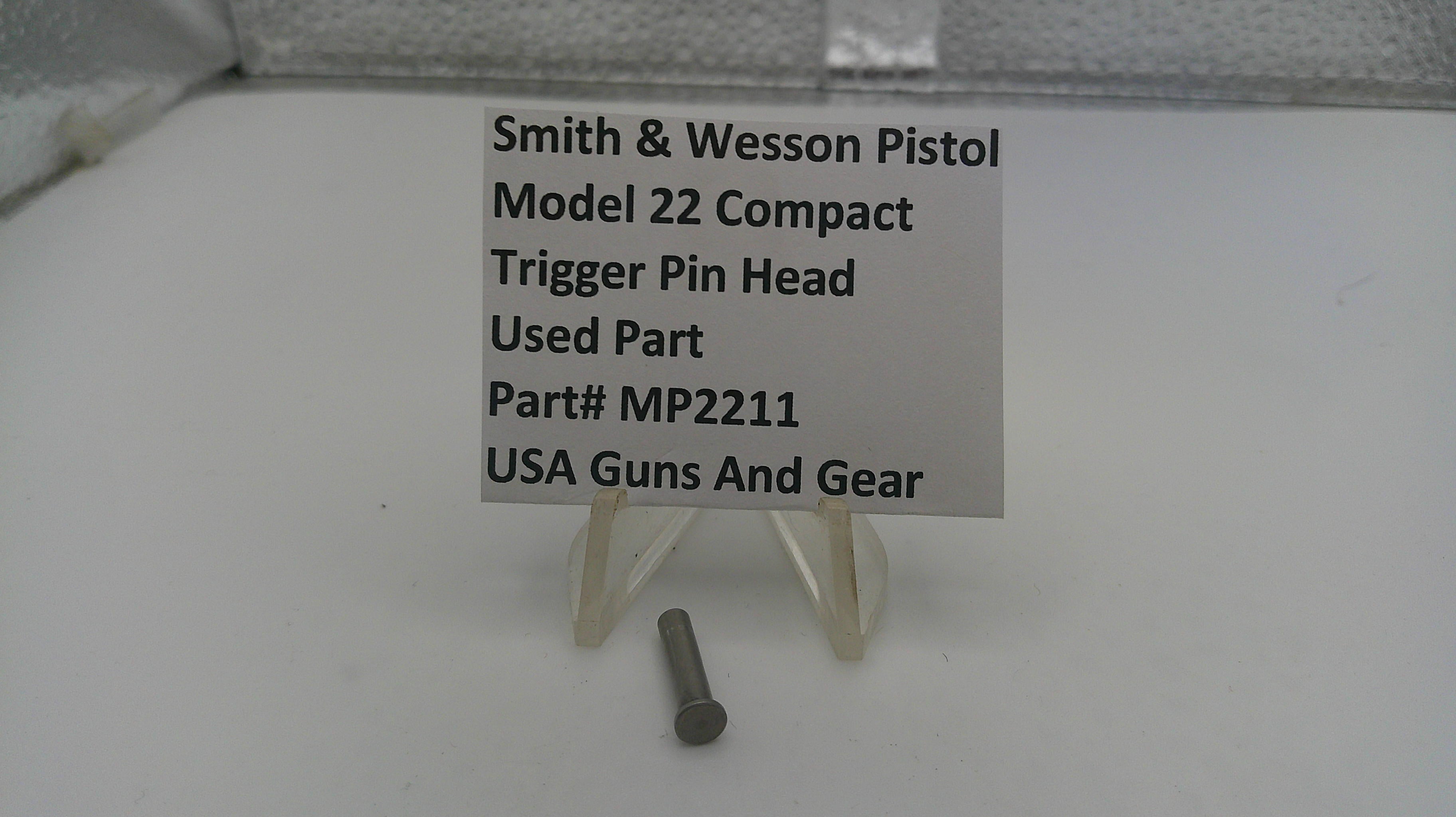 Smith & Wesson pistol trigger pin head on a stand with a label