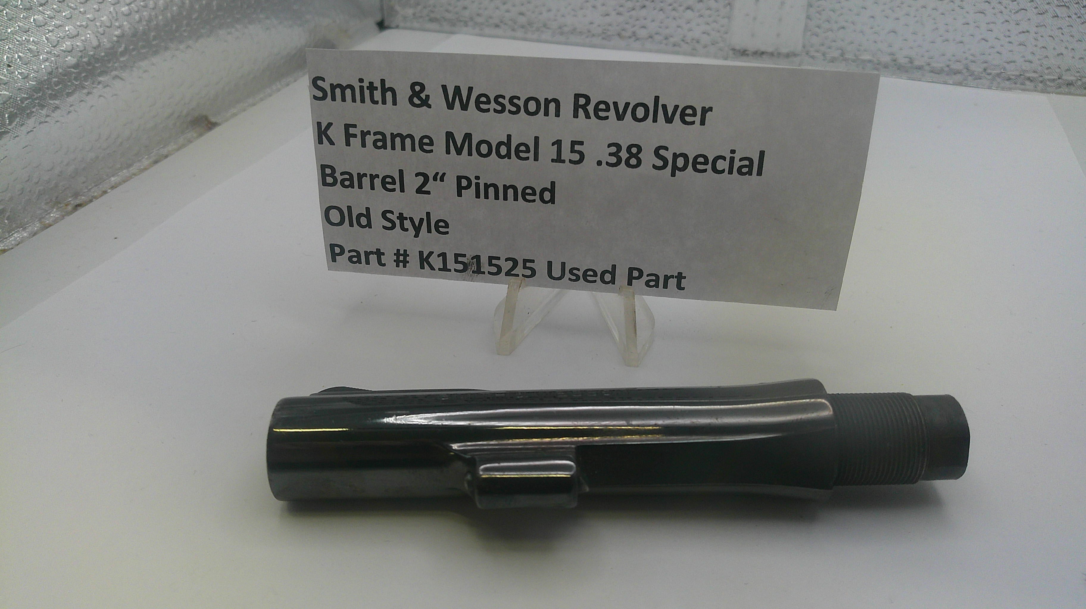 Smith & Wesson revolver part on a white surface with a label