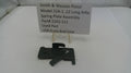 Black spring plate assembly for Smith & Wesson Pistol Model 22A-1 on a white surface with a label.