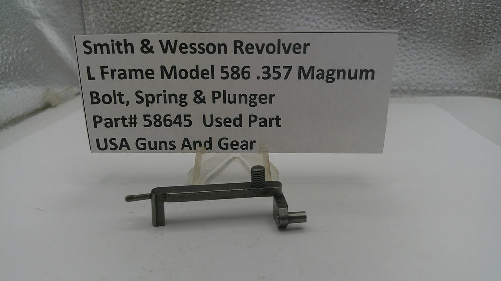 Used Smith & Wesson Revolver L Frame Model 586 .357 Magnum bolt, spring, and plunger on a white background with a label.