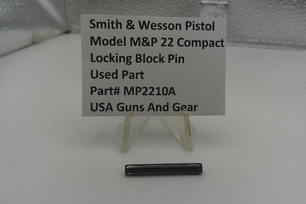 Smith & Wesson pistol part with a label on a white background
