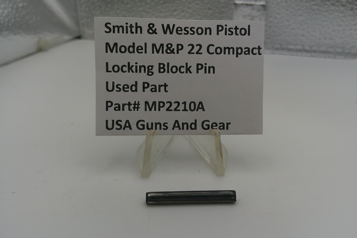 Smith & Wesson pistol part with a label on a white background