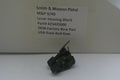 A small black metal lever housing block part for a Smith & Wesson pistol, displayed in front of its branded cardboard packaging box with a white label.