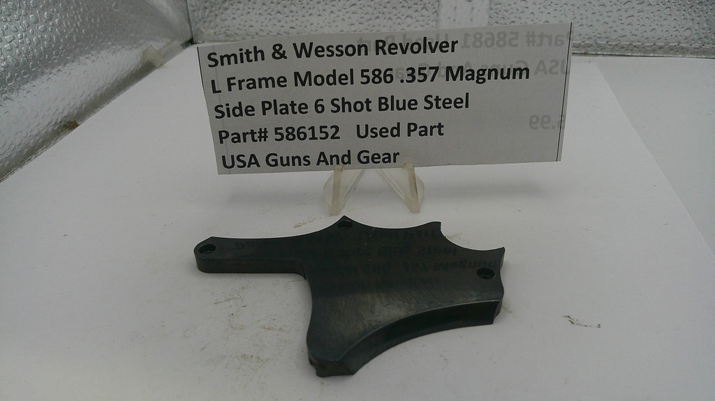 Black side plate of a Smith & Wesson revolver with a sign detailing product information on a white background.