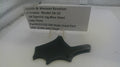 Black side plate for a Smith & Wesson revolver on a white surface with a label.