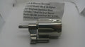 A used metallic revolver cylinder and frame component with a paper tag showing part details, photographed on a white background.