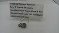 Smith & Wesson revolver thumb piece and nut with a label on a white background
