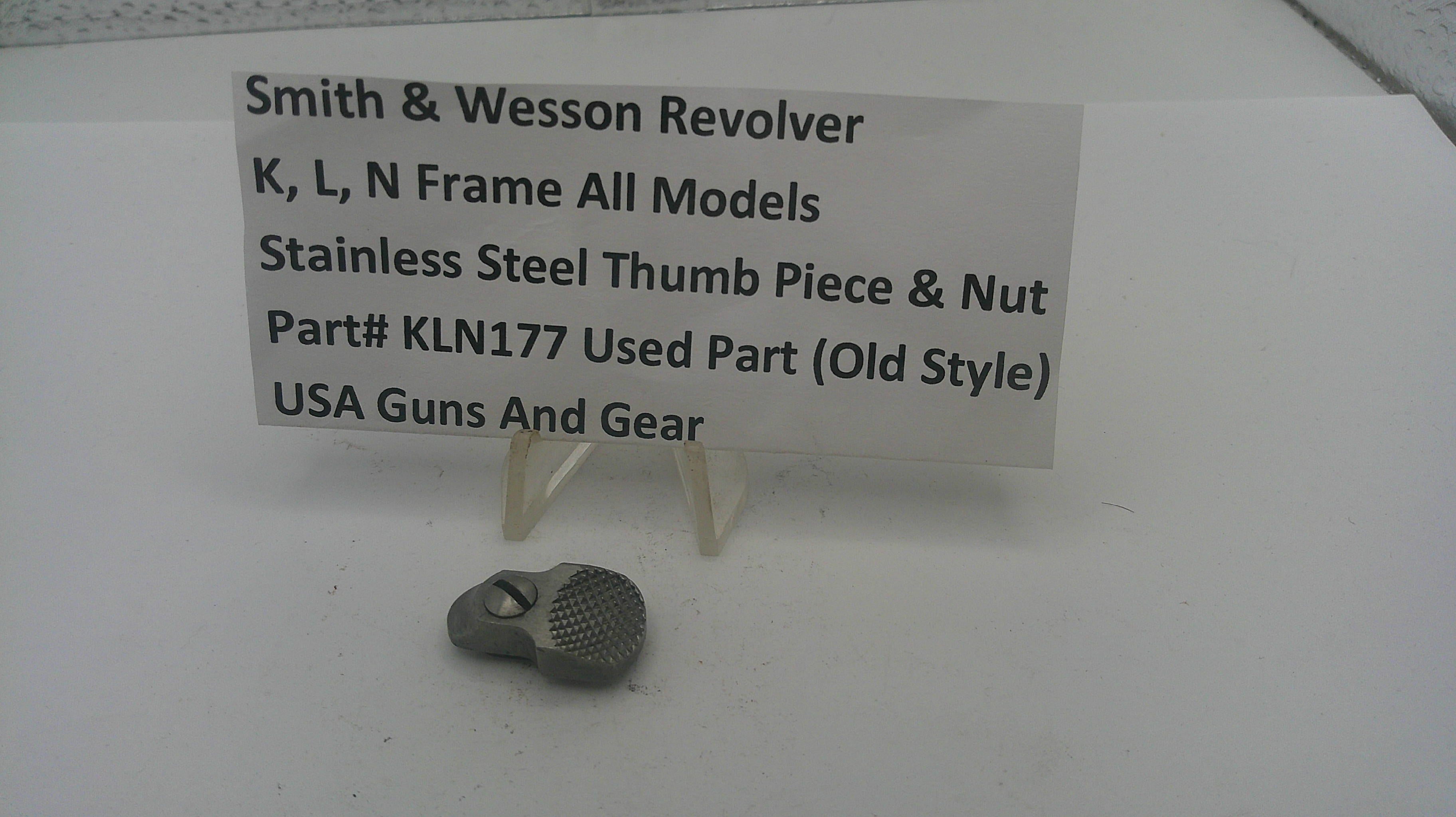 Smith & Wesson revolver thumb piece and nut with a label on a white background