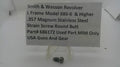 A small metal threaded screw part displayed on a clear plastic stand in front of a white sign that reads 'Smith & Wesson Revolver L Frame Model 686-6 & Higher .357 Magnum Stainless Steel Strain Screw Round Butt Part# 686172 Used Part MIM Only USA Guns And Gear'.