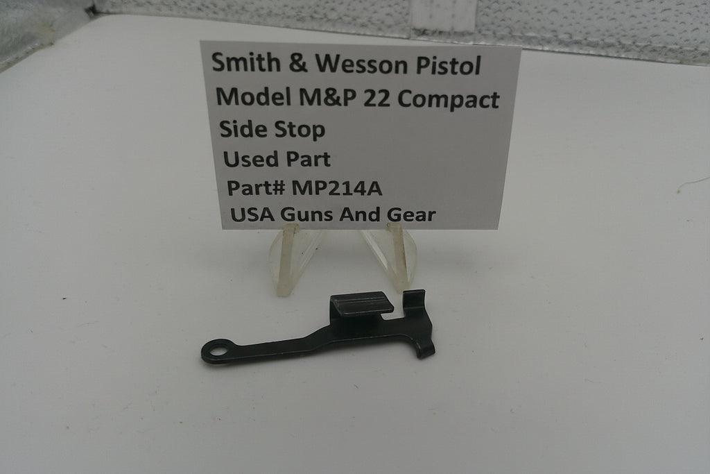 Smith & Wesson pistol part on a white surface with a label