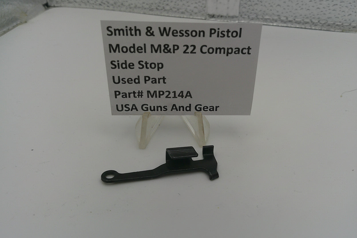 Smith & Wesson pistol part on a white surface with a label