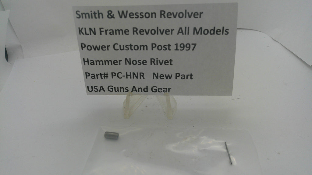 A small metal hammer nose rivet in a clear plastic bag next to a white sign that reads 'Smith & Wesson Revolver KLN Frame Revolver All Models Power Custom Post 1997 Hammer Nose Rivet Part# PC-HNR New Part USA Guns And Gear' on a white background.