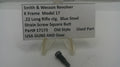 Smith & Wesson revolver part with descriptive sign on a white background