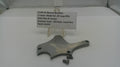 Metal component with a label on a white surface