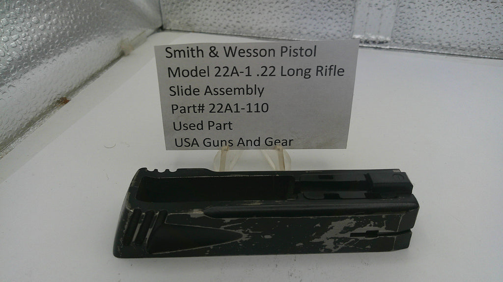 Smith & Wesson pistol slide assembly with a label on a white surface