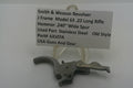 Smith & Wesson revolver part on a stand with descriptive label