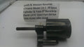A used black metal revolver cylinder and yoke part, labeled with part number 1470, shown on a white surface with a paper tag reading 'Smith & Wesson Revolver K Frame Model 14-2 .38 Special Cylinder & Yoke Barrel & Up'.