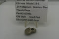 Smith & Wesson revolver thumb piece with descriptive sign on a white background