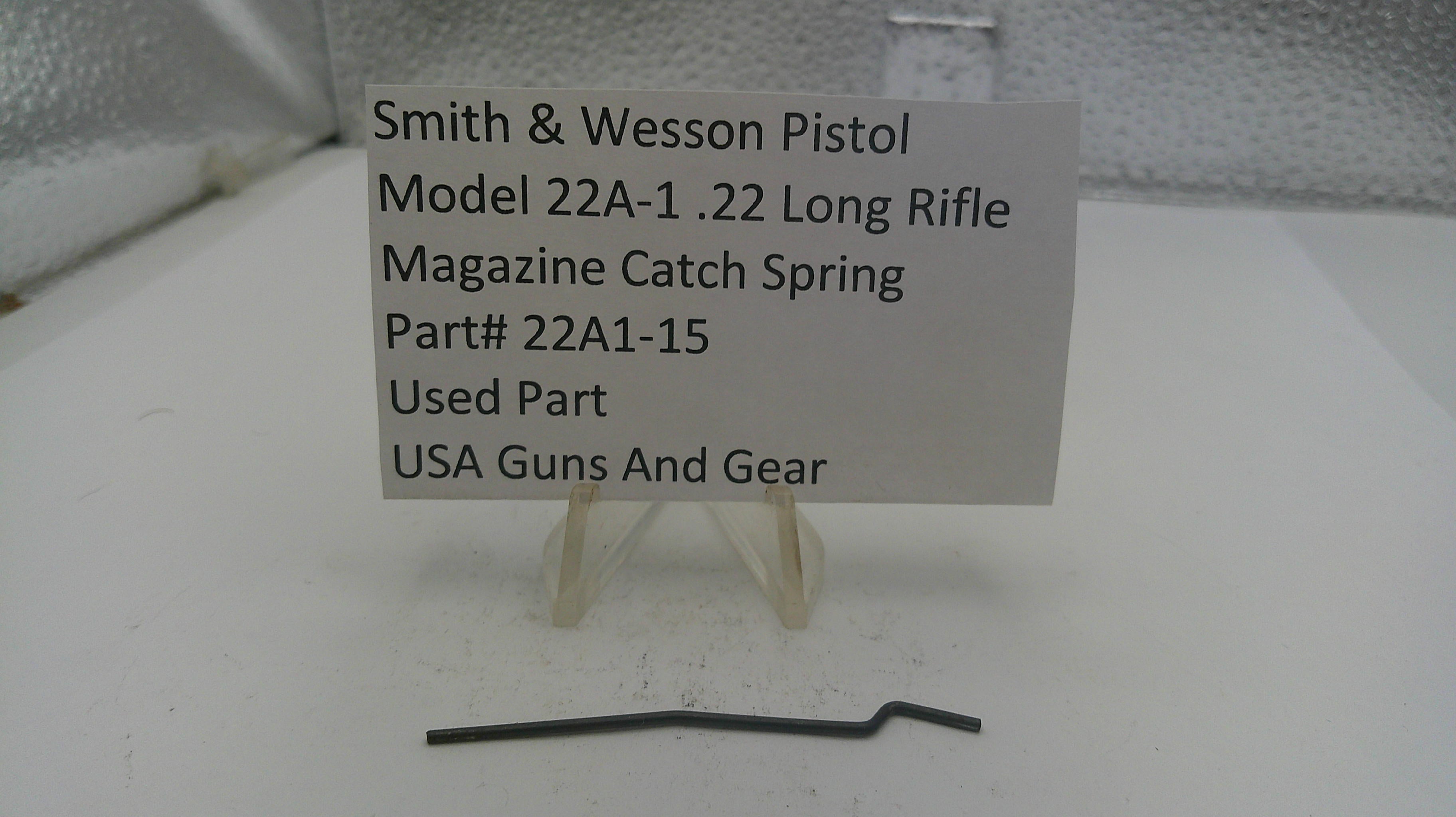 Smith & Wesson pistol magazine catch spring with a label on a white background