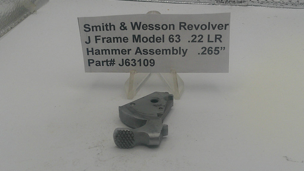 Smith & Wesson revolver hammer assembly with a label on a white background