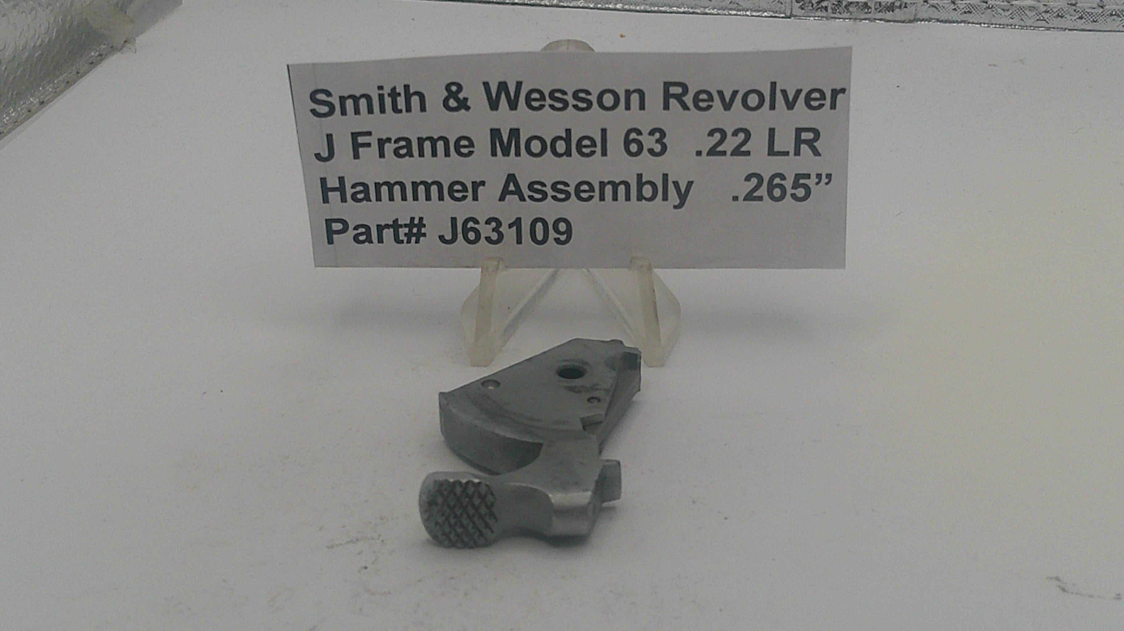 Smith & Wesson revolver hammer assembly with a label on a white background