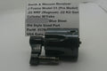 A used metal Smith & Wesson revolver cylinder and w/ye assembly, shown next to a handwritten paper label with part details.