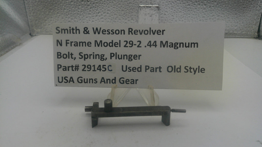 Smith & Wesson revolver part on a stand with a label