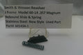 Smith & Wesson revolver slide and spring on a stand with descriptive card