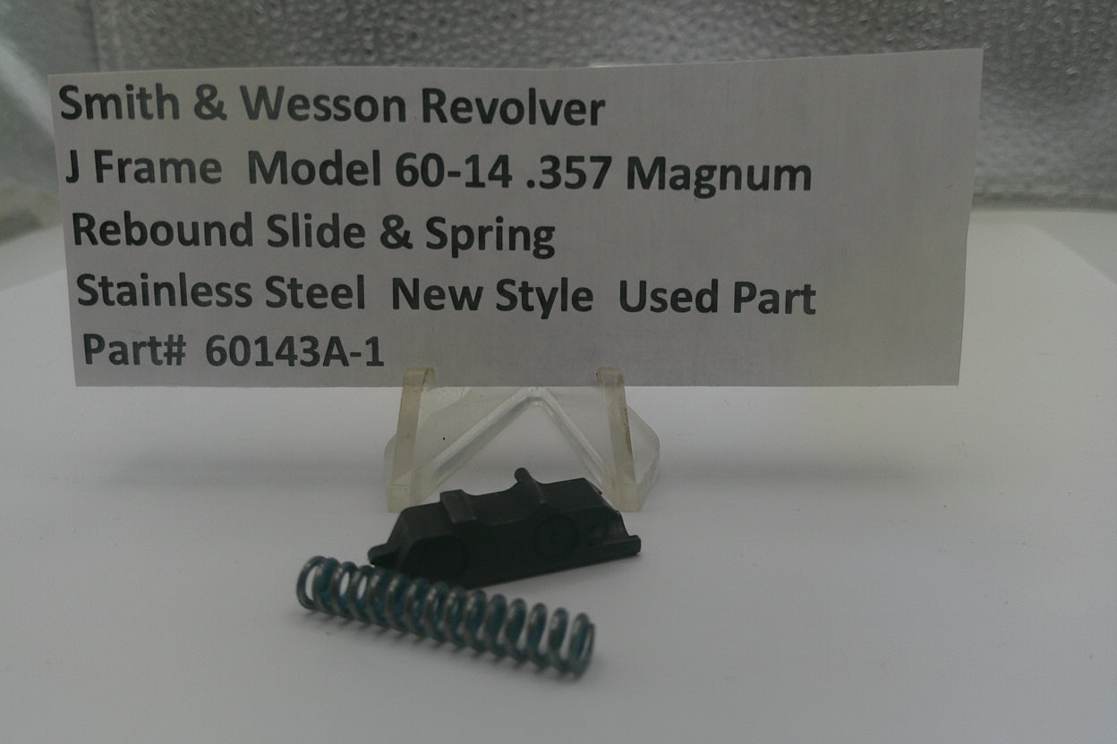 Smith & Wesson revolver slide and spring on a stand with descriptive card