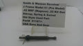 A used metal mechanical part for a Smith & Wesson revolver, displayed on a clear plastic stand with a paper label card. The label details the part number and compatibility.