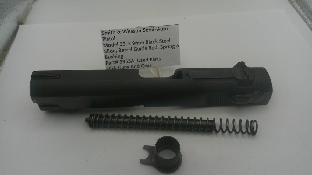 Smith & Wesson semi-auto pistol parts including slide, barrel guide rod, spring, and bushing on a white background.