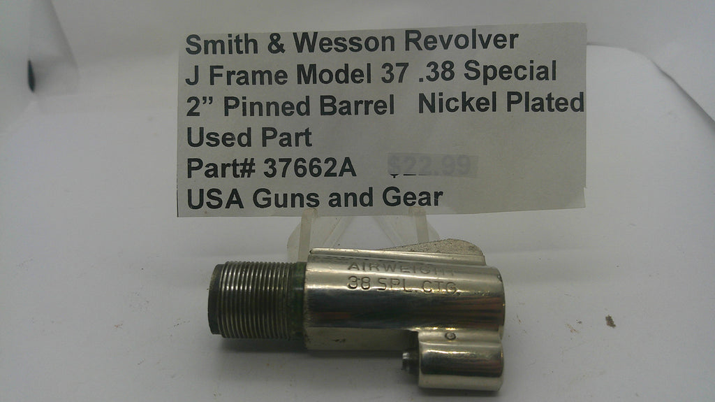 A used nickel-plated metal revolver barrel pinch block for a Smith & Wesson J Frame Model 37 .38 Special, with a handwritten price tag card above it on a white background.