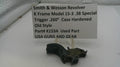 Smith & Wesson revolver part on a white surface with a label detailing specifications.