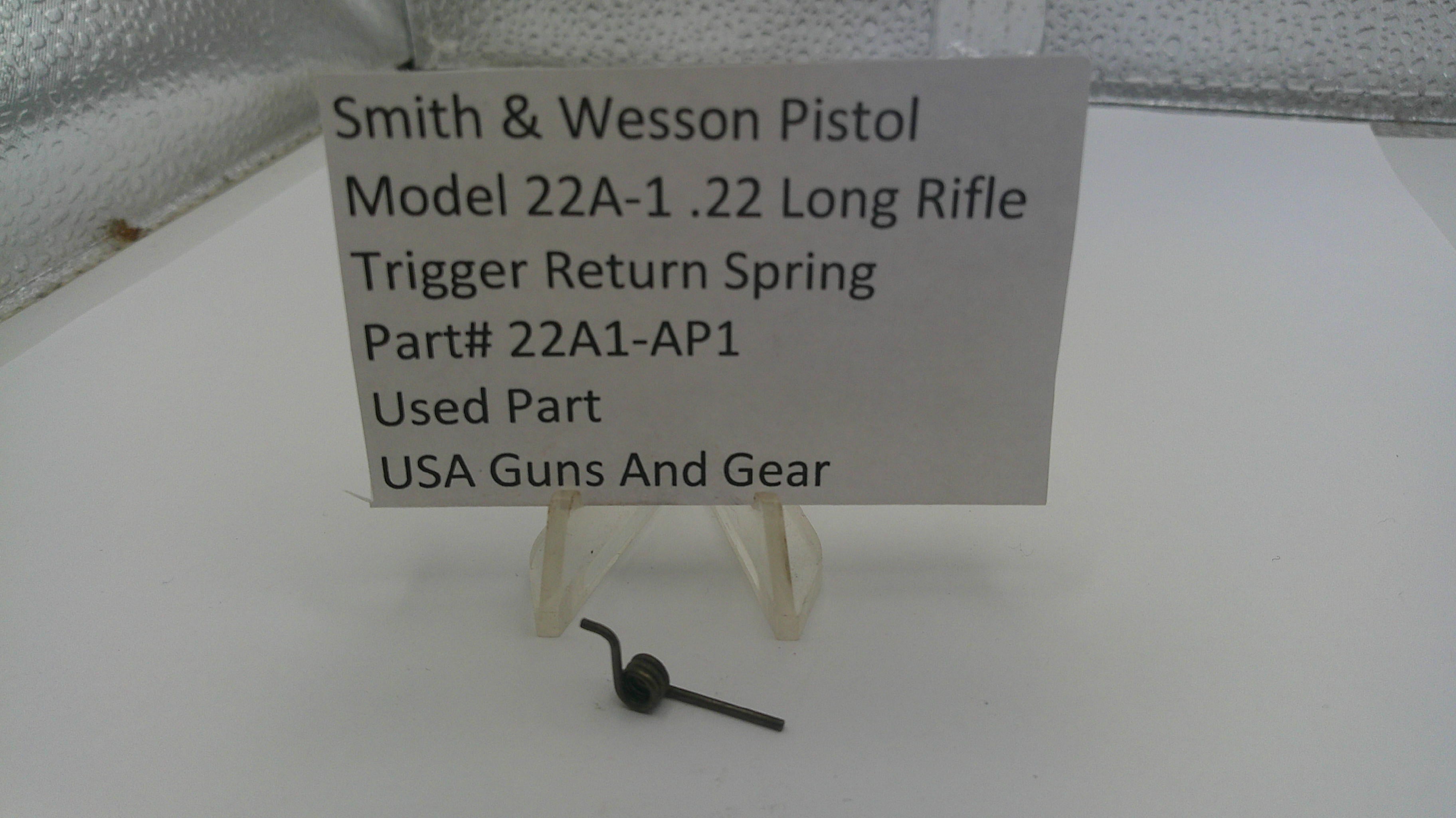 Smith & Wesson pistol trigger return spring with a label on a white background