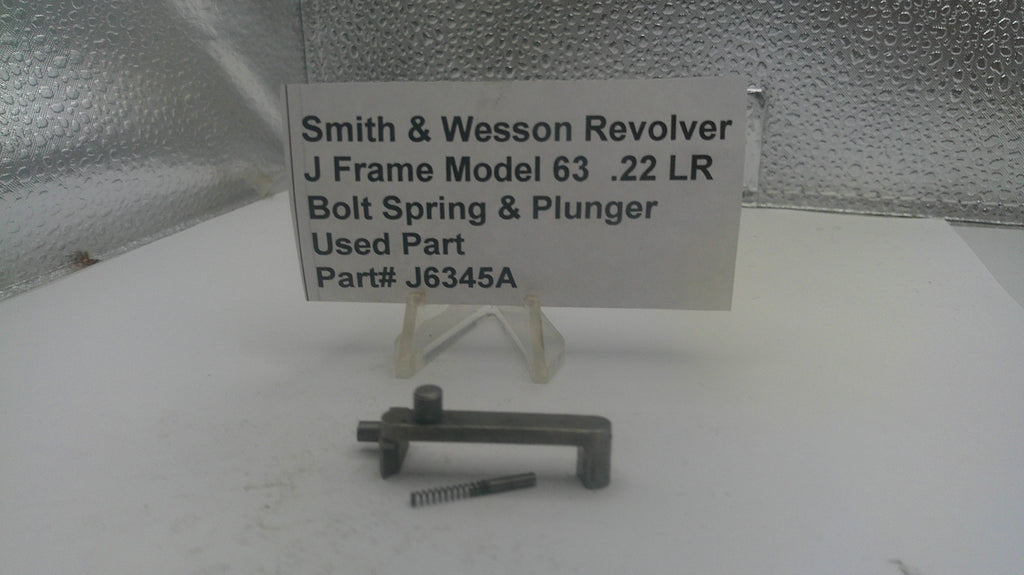 Smith & Wesson Revolver J Frame Model 63 .22 LR bolt spring and plunger on a white surface with a label.