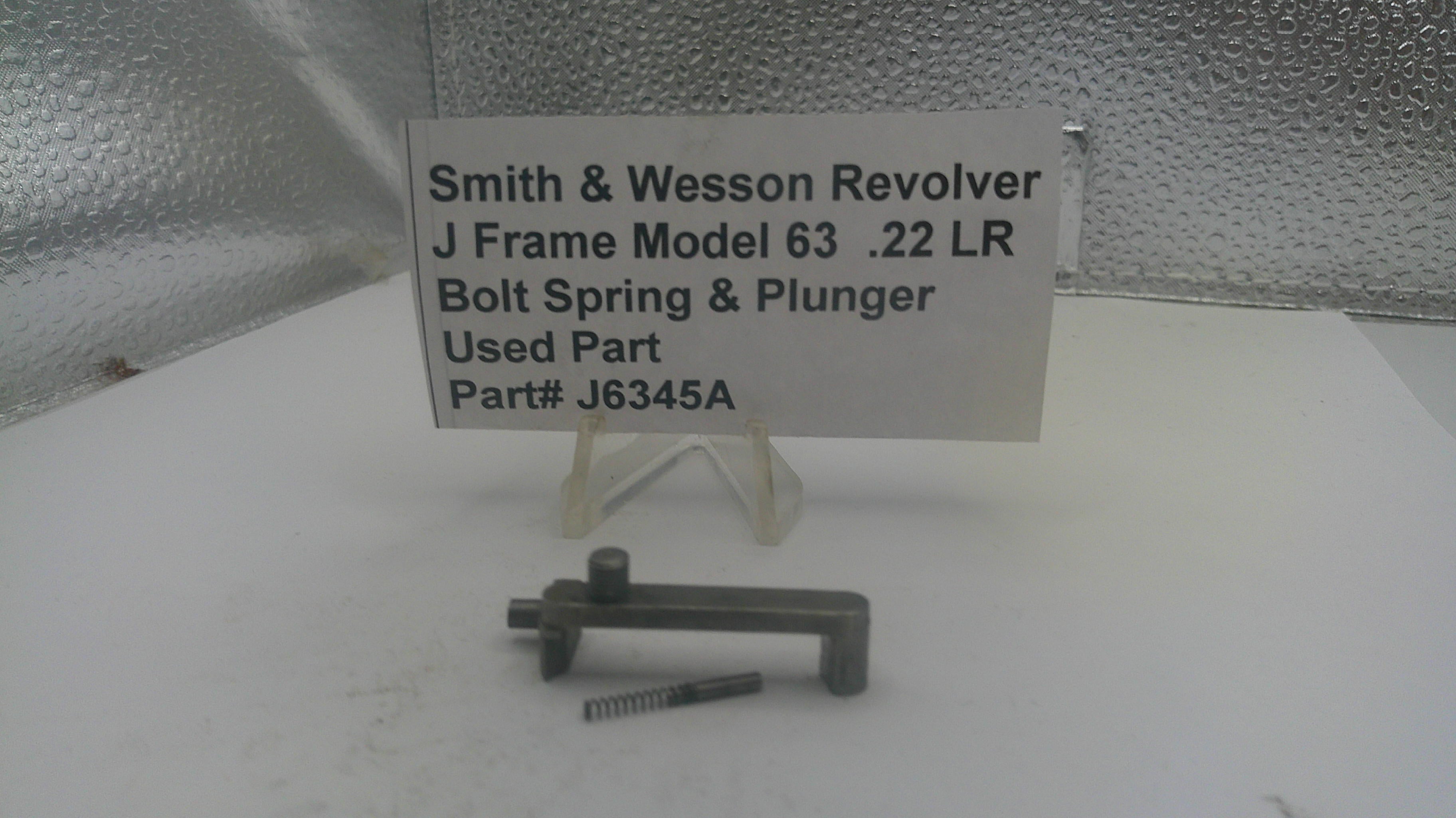 Smith & Wesson Revolver J Frame Model 63 .22 LR bolt spring and plunger on a white surface with a label.