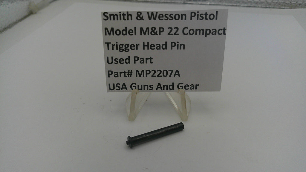 Smith & Wesson pistol trigger head pin with a label on a white background