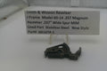 Smith & Wesson revolver part on a white surface with a label detailing specifications.