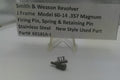 Smith & Wesson revolver firing pin and spring on a white background with a label.