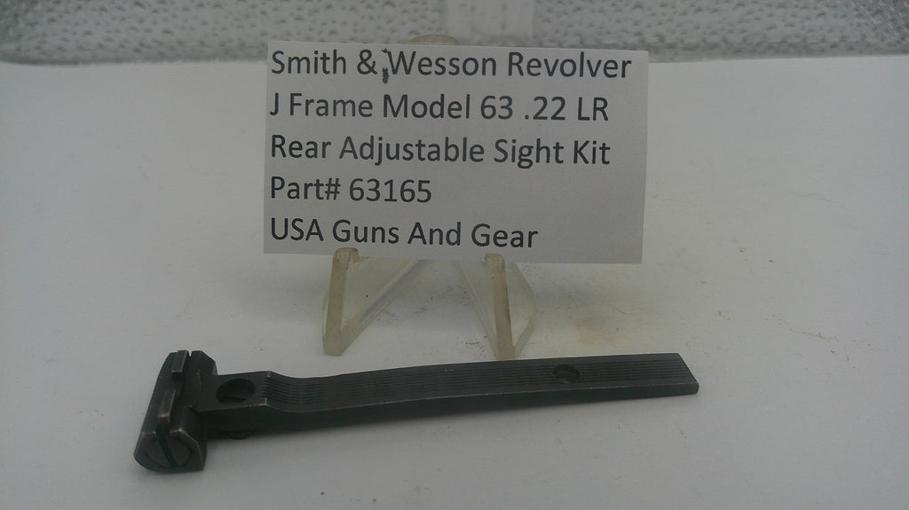 A black metal adjustable sight kit part for a Smith & Wesson revolver, displayed on a clear plastic stand with a white label card in the background.