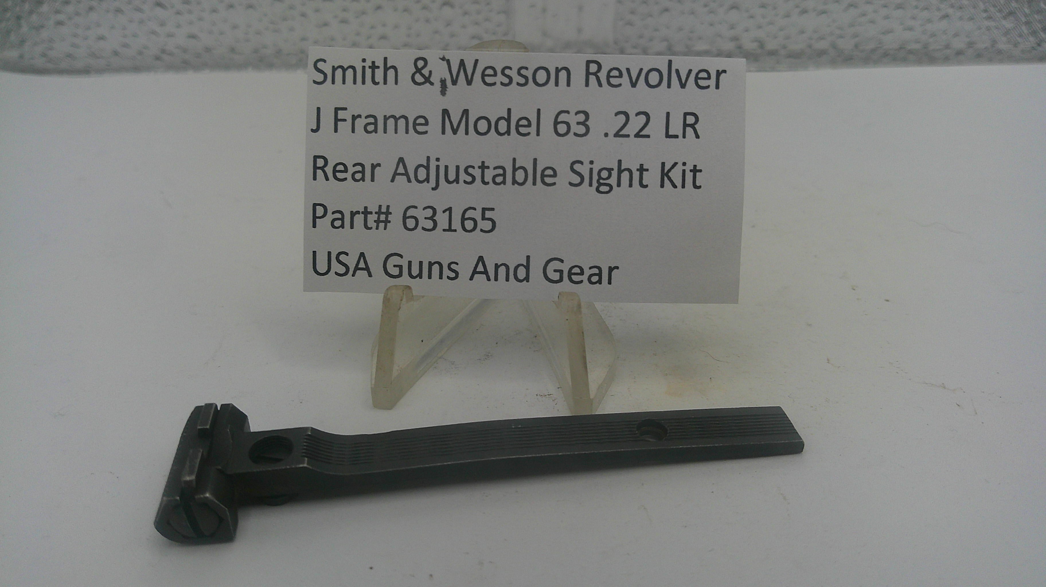 A black metal adjustable sight kit part for a Smith & Wesson revolver, displayed on a clear plastic stand with a white label card in the background.
