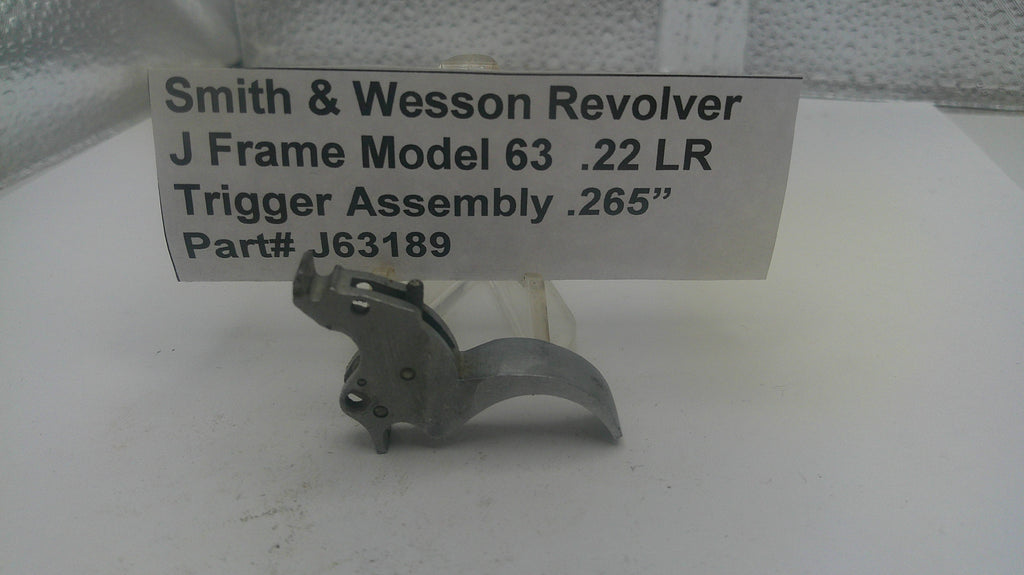 Smith & Wesson Revolver trigger assembly on a white surface with a label