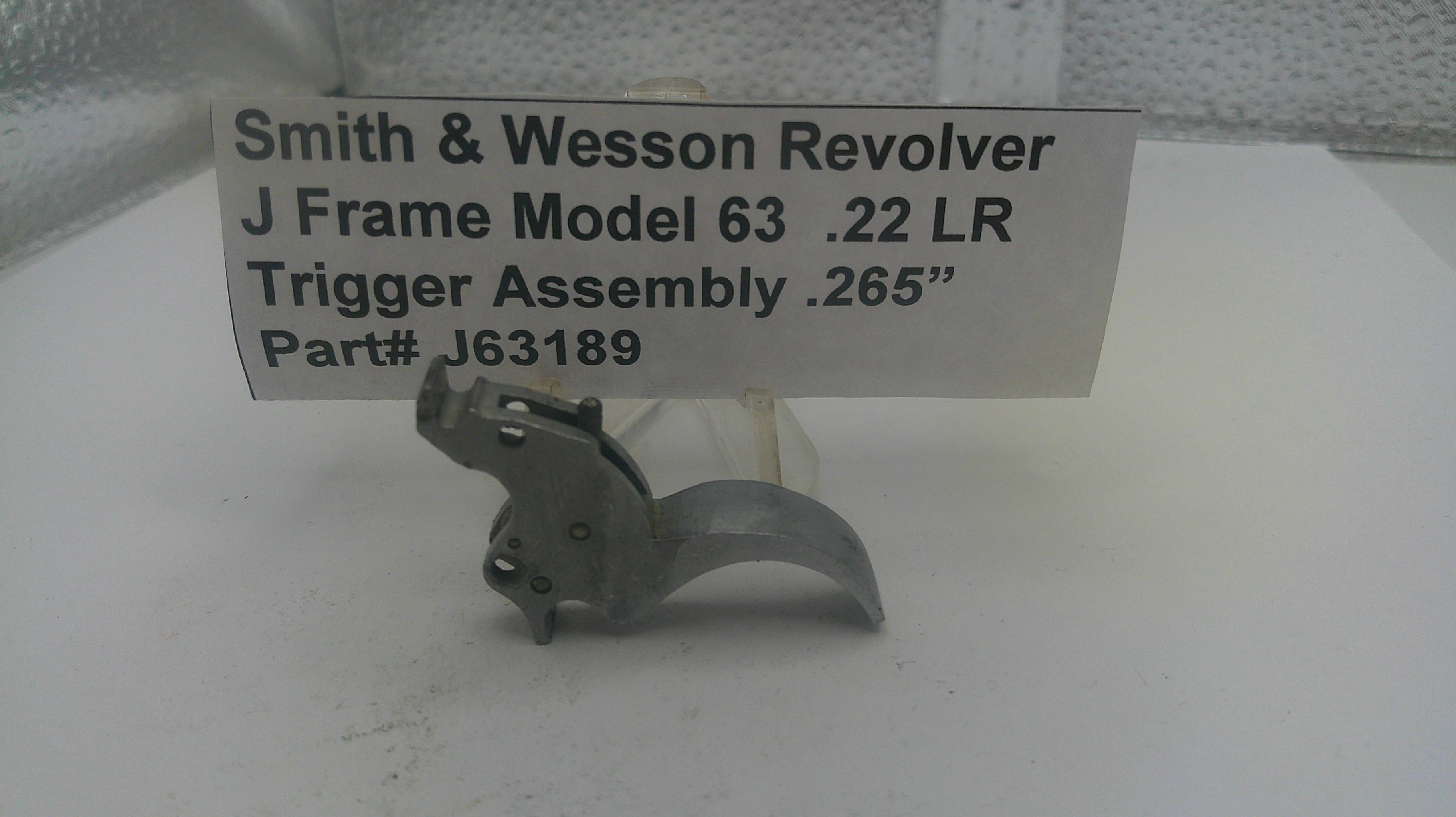 Smith & Wesson Revolver trigger assembly on a white surface with a label