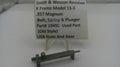 A small metal used part for a Smith & Wesson revolver, displayed on a clear plastic stand with a white label card. The label reads 'Smith & Wesson Revolver K Frame Model 13-3 .