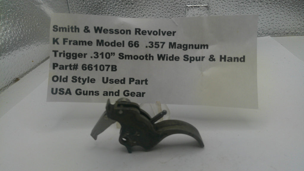 Smith & Wesson revolver trigger part with descriptive label on a white background