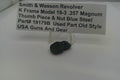 Black thumb piece and nut with a label detailing product information on a white background