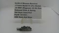 A used metal revolver slide and spring part displayed on a small clear stand, with a paper label card behind it reading 'Smith & Wesson Revolver J Frame Model 51 (Pre Model) .22 MRF (Magnum) .