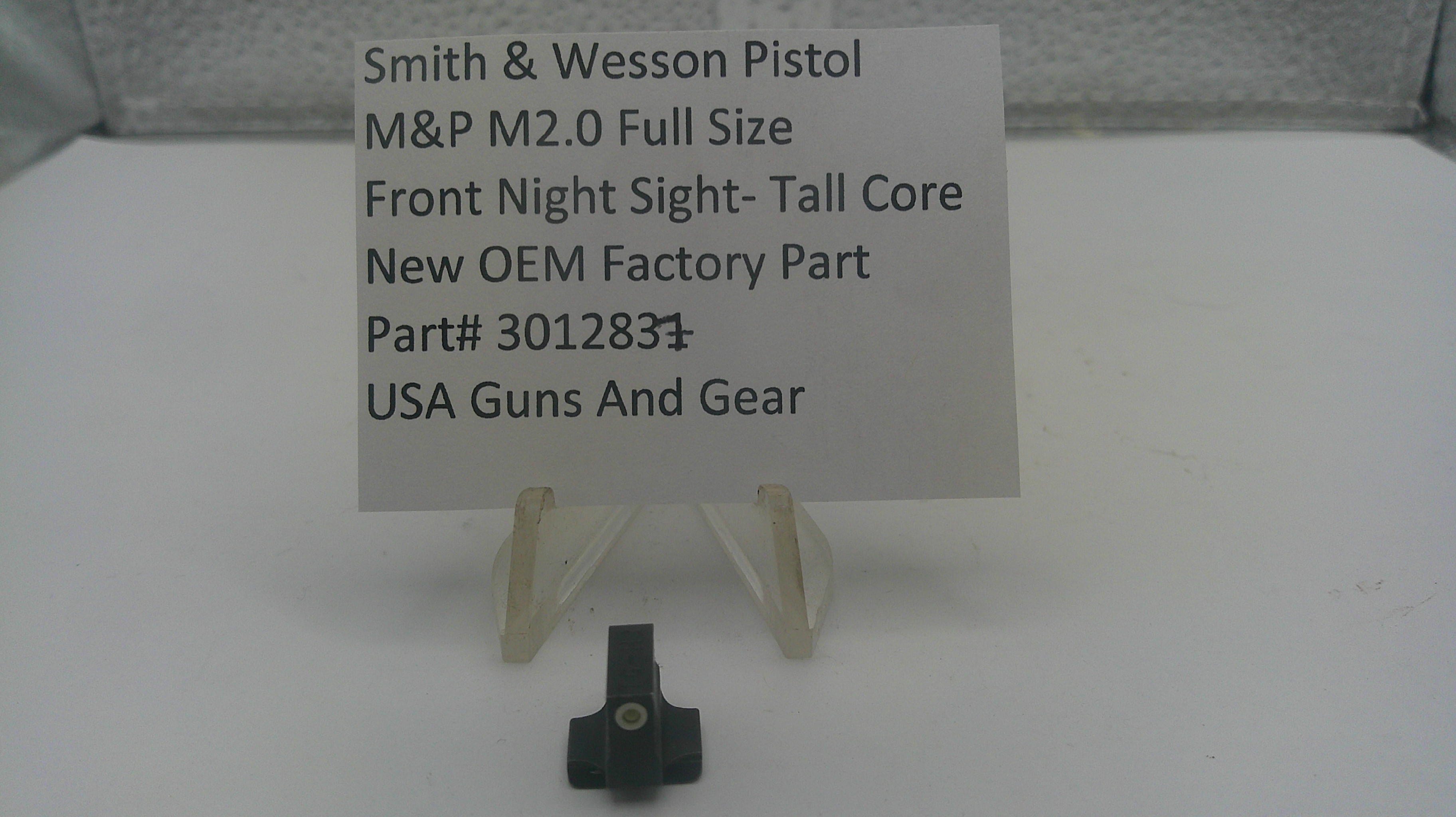 A small black metal firearm accessory part displayed on a clear plastic stand in front of a white sign that reads 'Smith & Wesson Pistol M&P M2.0 Full Size Front Night Sight-Tall Core New OEM Factory Part Part# 301283 USA Guns And Gear'.