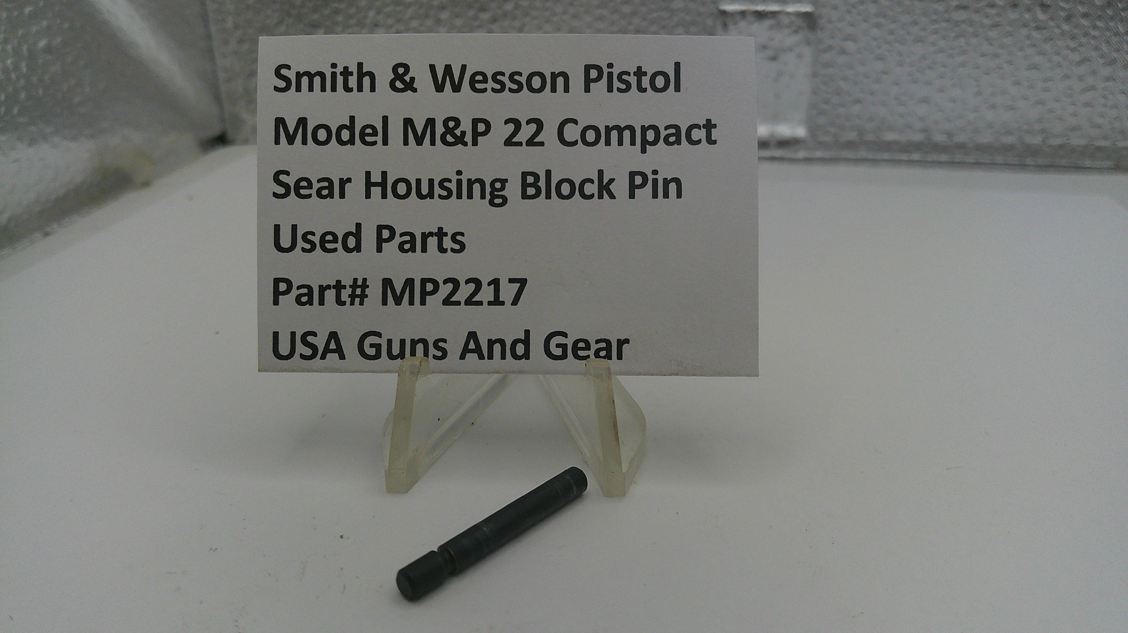 Black block pin with a sign indicating it is a used part for Smith & Wesson Pistol Model M&P 22 Compact, on a white surface.